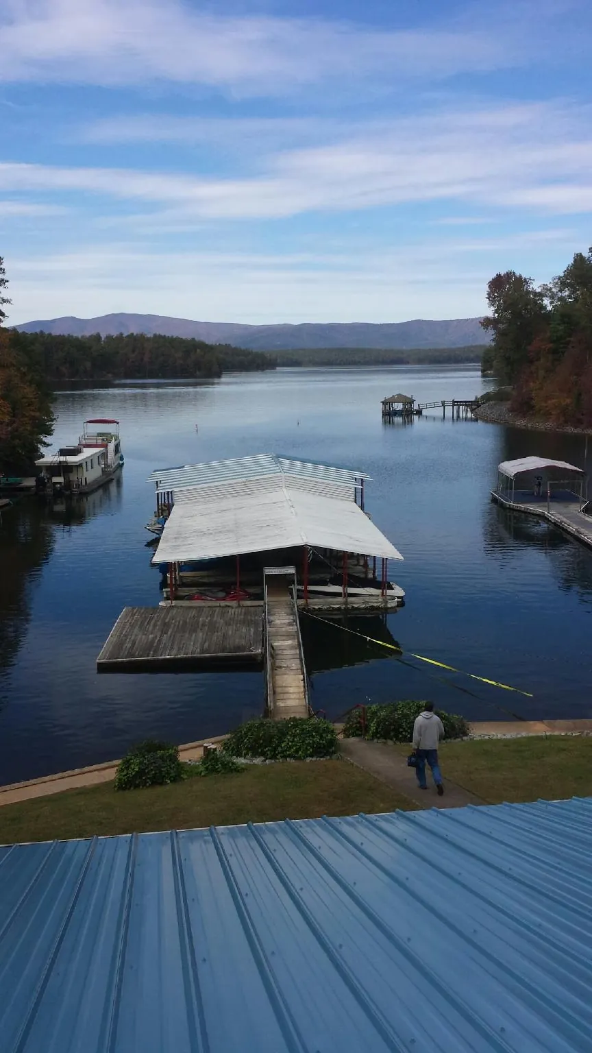 View across a lake from a newly installed blue metal roof in Berwick